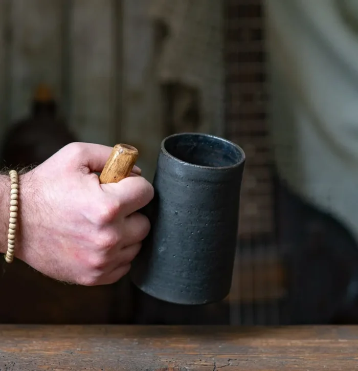 Dark rustic handmade ceramic mug with juniper wood