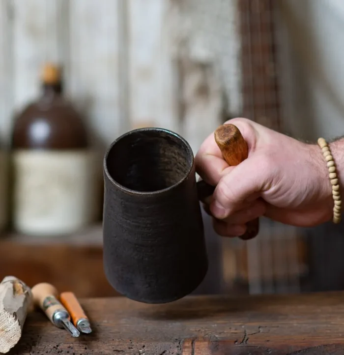 Dark rustic handmade ceramic mug with juniper wood