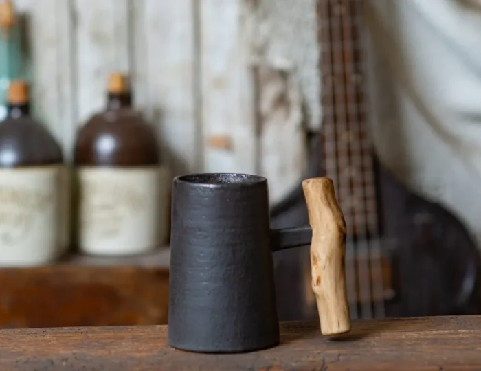 Dark rustic handmade ceramic mug with juniper wood