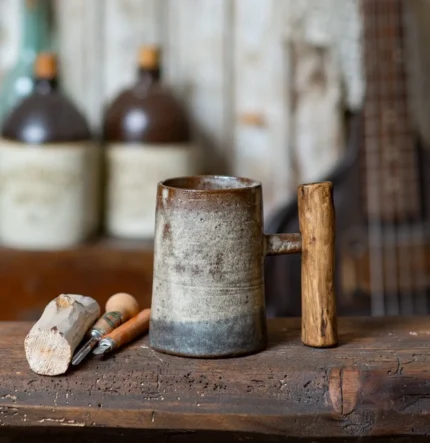 Tall rustic cozy beige ceramic mug with juniper wood handle