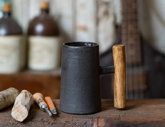 Dark rustic handmade ceramic mug with juniper wood