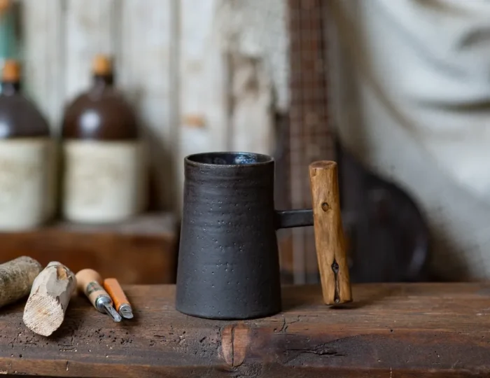 Dark rustic handmade ceramic mug with juniper wood